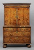 An 18th century burr walnut cabinet on chest
The moulded rectangular cornice above a cushion moulded