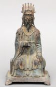 A Chinese archaistic style patinated bronze figure of a deity
Modelled seated in flowing robes and