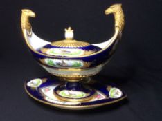 A 19th century Sevres style lidded sauce tureen on stand
The removable lid flanked by gilt painted