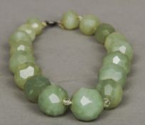 A carved jade necklace
Each graduated bead faceted.  43 cm long overall. CONDITION REPORTS: