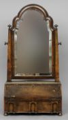 An 18th century style walnut dressing table mirror
The cushion moulded framed bevelled plate