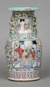 A 19th century Chinese porcelain vase
Decorated with figural vignettes on a floral ground