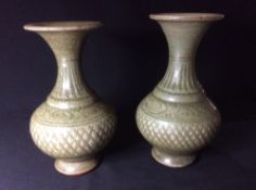 A matched pair of 19th century Korean pottery vases
Each with incised decoration and celadon glaze.