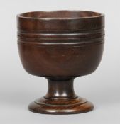 A turned lignum vitae wassail bowl
With banded decoration.  20.5 cm high.  CONDITION REPORTS: