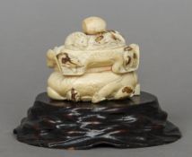 A late 19th century Japanese carved ivory box and cover
Formed as mice in a loosely tied sack, one