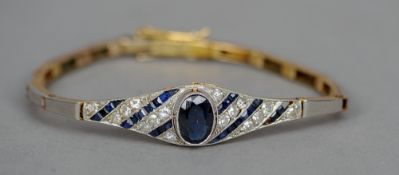 An 18 ct gold diamond and sapphire set bracelet
Of reticulated form, with bands of diamond and