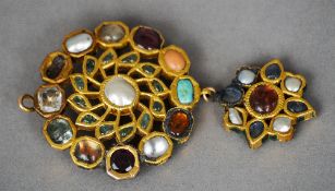 An Indian Mughal unmarked gold brooch
Of double target form inset with various specimen stones,