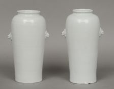 A matched pair of 17th century blanc de chine vases
Both with applied beast masks, one with Anhua