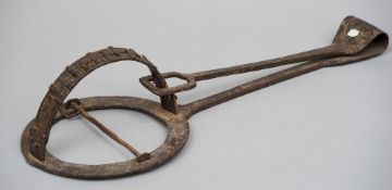 A 19th century steel animal trap
Of typical construction.  70 cm long. CONDITION REPORTS: