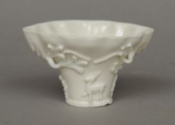 A fine early 18th century Chinese Fukien  blanc de chine porcelain libation cup 
With raised deer