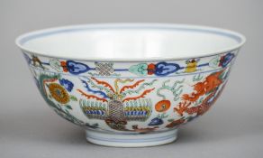 A Chinese porcelain bowl
Decorated with dragons chasing flaming pearls and phoenixes, the interior