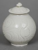 A Chinese porcelain white glazed vase and cover
Anhua decorated with flowering scrolls, the cover