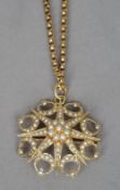 A Victorian seed pearl set 15 ct gold pendant on 9 ct gold chain
The pendant formed as an eight
