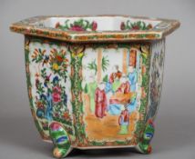 A Chinese Canton porcelain jardiniere
Of hexagonal section, typically decorated.  20 cm high.