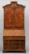 An 18th century burr walnut bureau bookcase
The arched domed top above twin feather banded