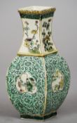 A Chinese porcelain vase
Of square section decorated with peach figural vignettes on a lotus