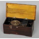 A late 19th century Helvetia disc music box
The simulated crossbanded top centred with a fan