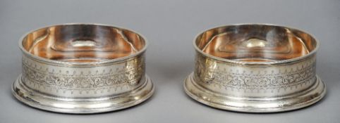 A pair of Elkington & Co. silver plated magnum bottle coasters
Each of typical circular form with