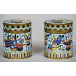 A pair of Chinese cloisonne caddies and covers
Of circular section decorated with precious objects.