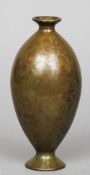 An Eastern patinated bronze vase
Of ovoid form with scrollwork decoration, the underside with