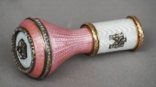 A Russian gold, enamel and diamond decorated cane handle
The top inset with a crown, the side with