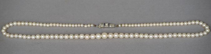 A single strand pearl necklace
With diamond and sapphire set white metal clasp, the pearls