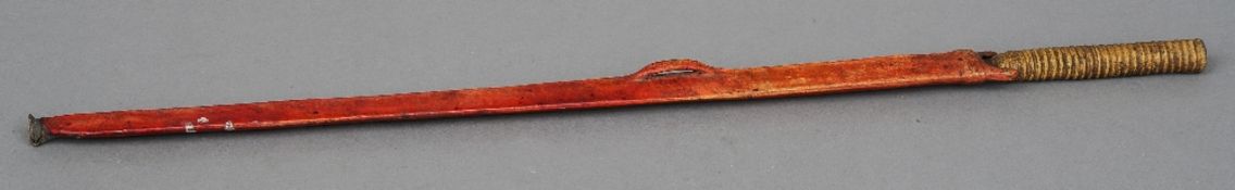 An East African Maasai tribal sword
With vellum bound handle and stained vellum sheath.  76 cm long.