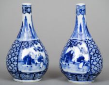 A pair of Chinese porcelain blue and white vases
Of slender baluster form, decorated with figural