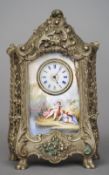 An enamel decorated desk clock
Formed as a rococo style vitrine fronted with an enamel panel