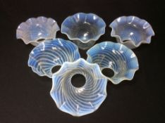 Six vaseline glass shades
Each with wavy rim and spiral moulding.  15 cm diameter.  (6) CONDITION