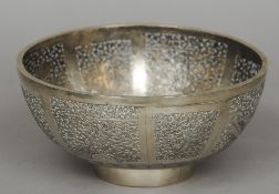 A Chinese white metal pierced bowl
Decorated with scrollwork vignettes, standing on a tapering foot,