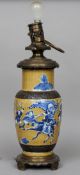 A Chinese bronze mounted blue decorated vase, converted to a lamp
The baluster vase decorated with