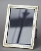 A large enamel decorated unmarked silver photograph frame
Of rectangular form with floral