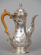 A George III silver coffee pot, hallmarked London 1762, maker's mark indistinct
The later embossed