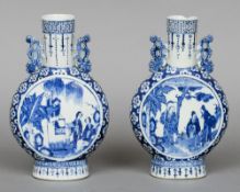 A pair of 19th century Chinese blue and white moon flasks
Of typical form with twin pierced