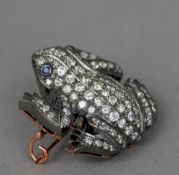 An unmarked diamond and sapphire set brooch
Formed as a frog, the body overall set with diamonds and