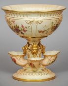 A Royal Worcester porcelain centrepiece
The central bowl supported on mystical beast mask headed