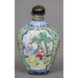 A Chinese Canton enamel snuff bottle and stopper
Decorated with figural vignettes on a lotus