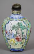 A Chinese Canton enamel snuff bottle and stopper
Decorated with figural vignettes on a lotus