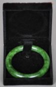 A Chinese carved spinach jade bangle
8.5 cm diameter.
 CONDITION REPORTS: Generally in good