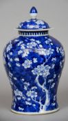 A Chinese blue and white porcelain baluster vase and cover Decorated overall with prunus blossom,