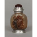 A late 18th/early 19th century Chinese white metal mounted carved brown agate snuff bottle and
