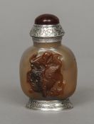 A late 18th/early 19th century Chinese white metal mounted carved brown agate snuff bottle and