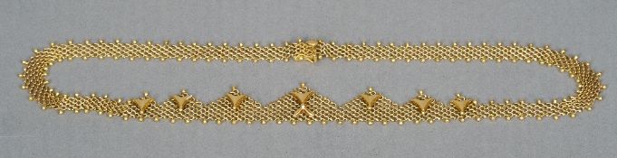 An 18 ct gold mesh form necklace
Fronted with lozenge designs.  44.5 cm long. CONDITION REPORTS: