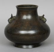 A 19th century Oriental bronze vase 
Of bulbous form with mythical beast mask decoration, standing