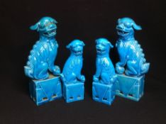 Two pairs of Chinese porcelain dogs-of-fo
Typically modelled with allover turquoise glaze.  The