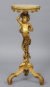 A 19th century giltwood figural torchere
The circular top supported by the figural column,