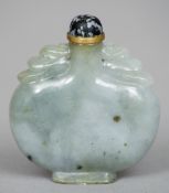 A Chinese carved jade snuff bottle and stopper
The shoulders carved with stylised dragon masks.  6.5