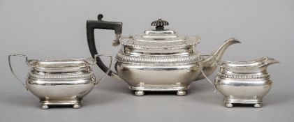 A George V silver three piece tea set, the teapot hallmarked Sheffield 1918, maker's mark of