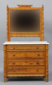 A 19th century pitch pine and faux bamboo dressing table
The mirrored back above the marble top